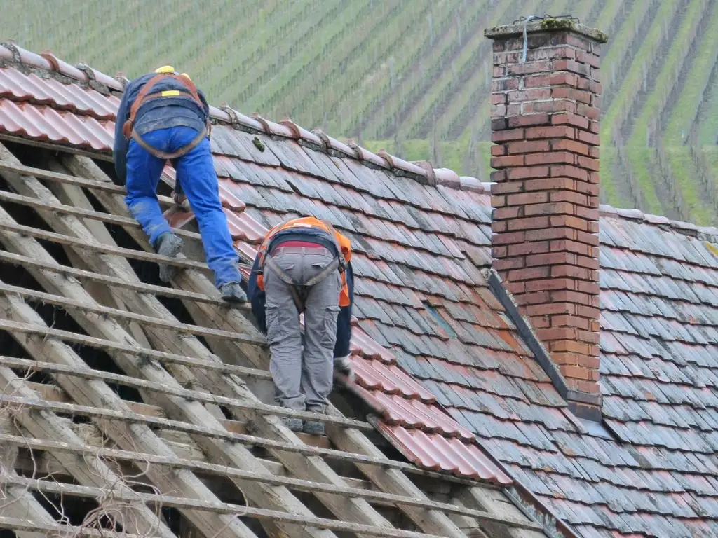 Roofers repairing a house roof in Los Angeles